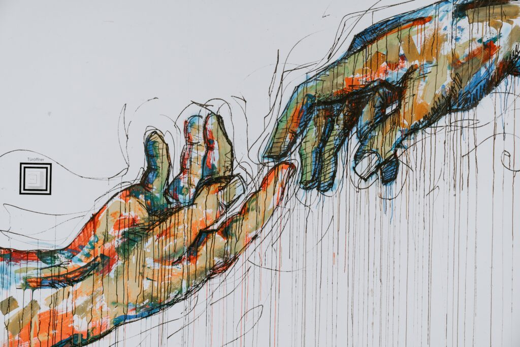 two human hands painting- showing the contact Relation with People interested in Real state